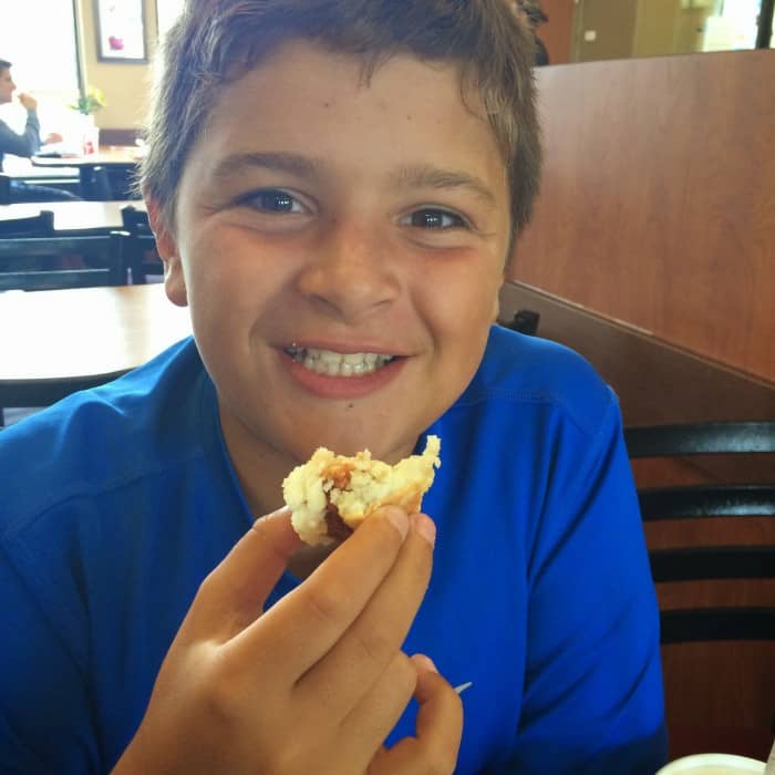 boy eating Chic-fil-A breakfast biscuit
