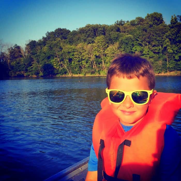 kid on a rowboat at Winton Woods