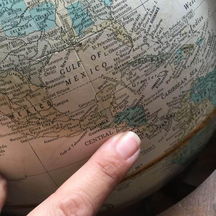 pointing at a globe