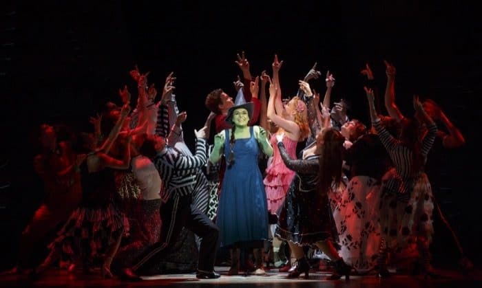 Jessica Vosk as Elphaba and Ginna Claire Mason as Glinda and the North American Touring Company of WICKED. Photo by Joan Marcus