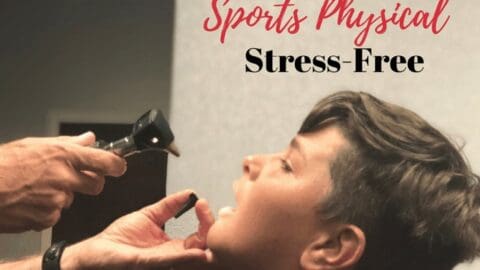 A medical professional examines a childs throat during a sports physical.