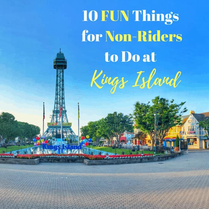 Kings Islands Eiffel Tower replica stands tall over a fountain with colorful balloons.