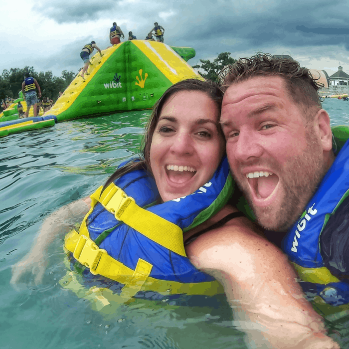 Adults having fun inflatable water park