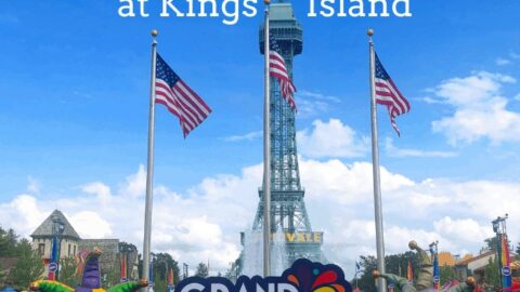 Kings Islands Grand Carnivale entrance with flags, jester heads, and Eiffel Tower.