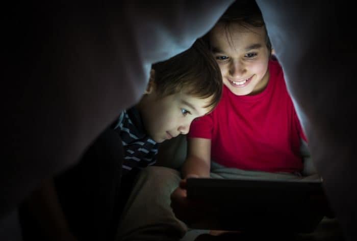 kids watching a movie on a tablet