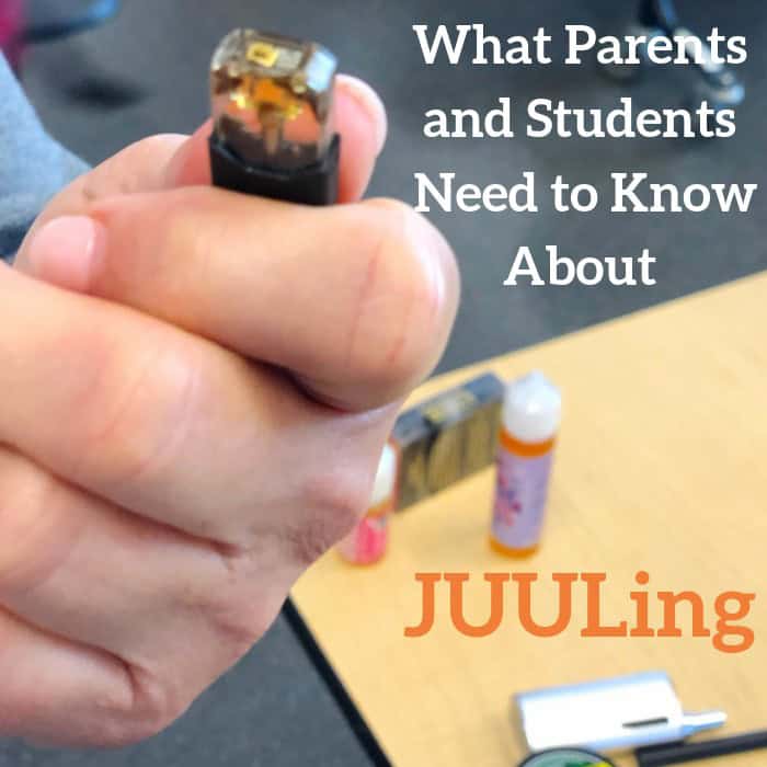 Hand holding a JUUL pod with vaping supplies and text about JUULing on a table.