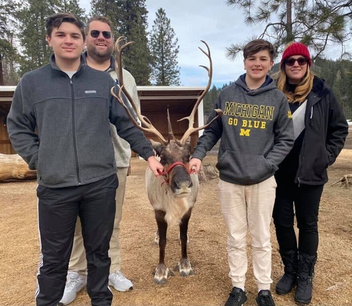 Adventure mom and family with reindeer at Leavenworth Reindeer Farm