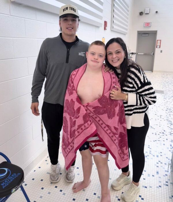 siblings with their brother with Down Syndrome