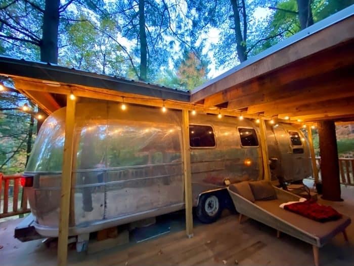 the patio deck for The Silver Bullet Airstream Treehouse
