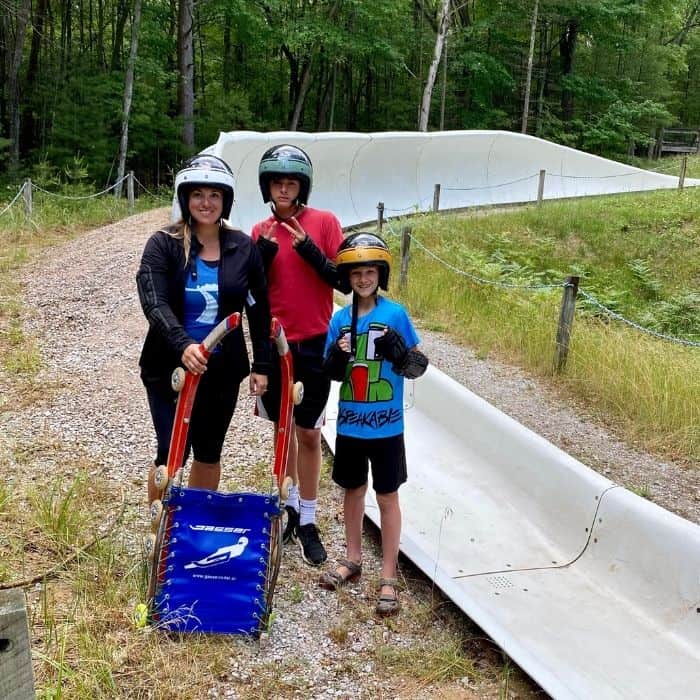 family with next to the summer wheel luge in Muskegon