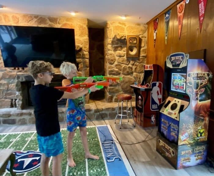 boys playing in Stadium Game Room at the Go Lodge game themed mansion