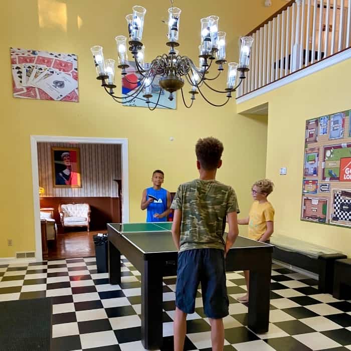 boys playing in foyer at the Go Lodge game themed mansion 