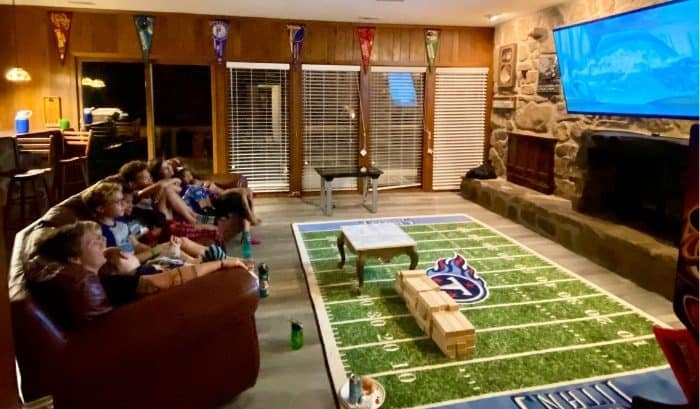 kids and parents watching a movie in the Stadium Game Room at the Go Lodge game themed mansion