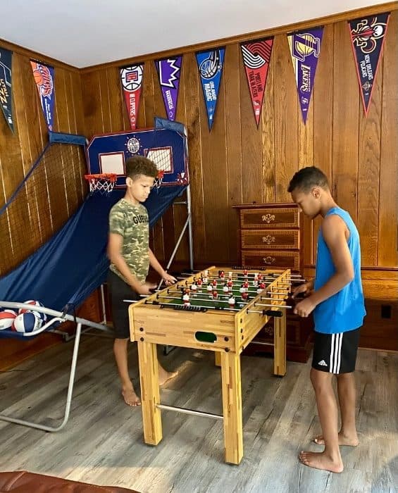 kids playing in The Stadium Game Room at the Go Lodge game themed mansion
