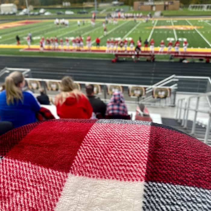 cozy checkered throw blanket at a football game