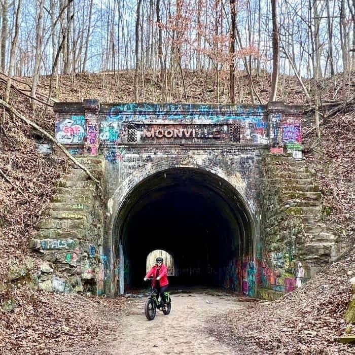 bike rider at entrance of Moonville Tunnel 