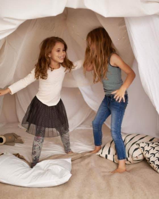 girls in a blanket fort