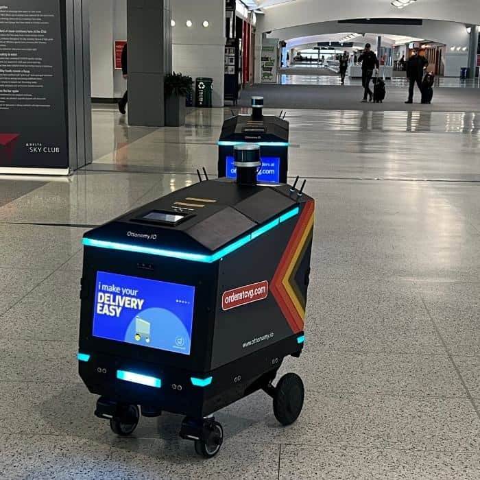 Nedra McDaniel with autonomous delivery robot at CVG Airport 