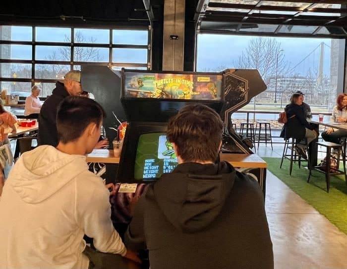 teenagers playing at 16-Bit Bar & Arcade in Dublin Ohio