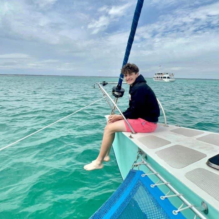 teenage boy on sail boat 