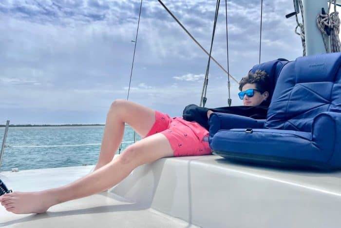 teenager relaxing on sail boat