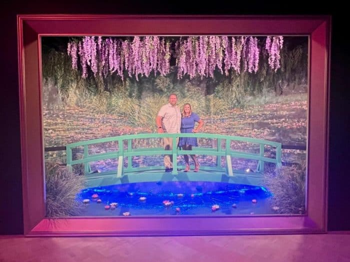 couple in giant water lily painting photo op  at Monet and Friends live