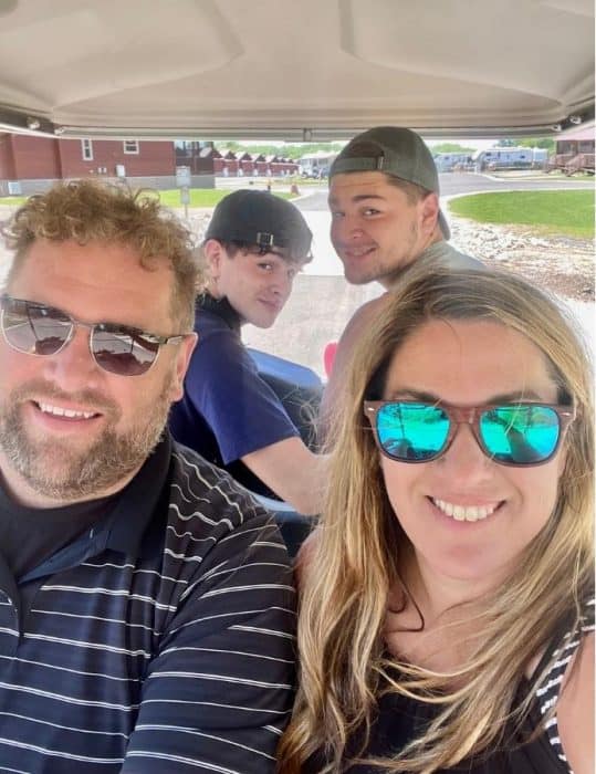 Nedra McDaniel and family in golf cart