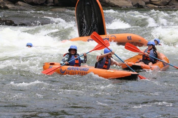 Nedra McDaniel in inflatable kayak on Surprise rapid Upper New River