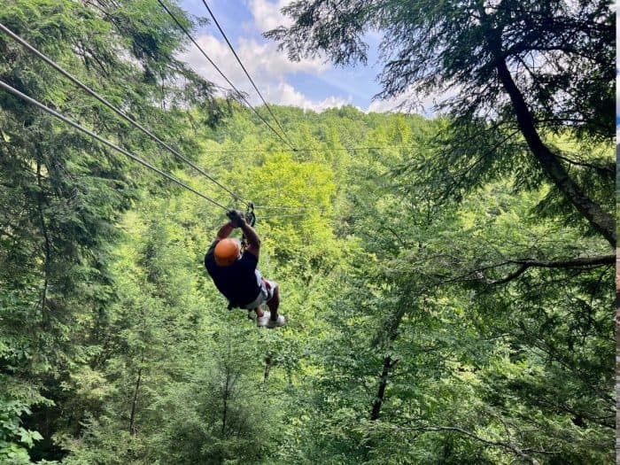 man ziplining Treetops Zipline Canopy Tour