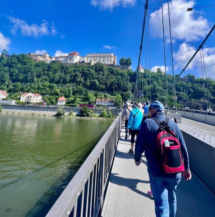 people walking across bridge in Passau Germany