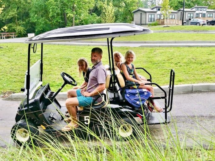 family on golf cart