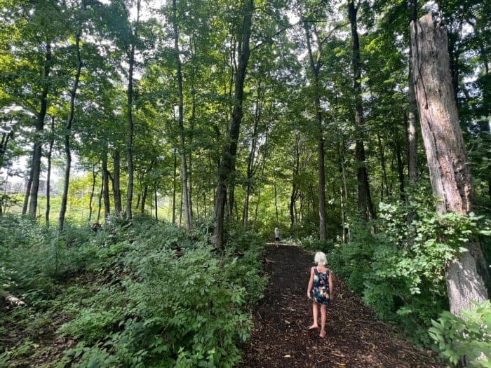 little girl on Little Miami walking trail in the woods Camp Cedar