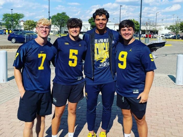 Students with football player at University of Michigan 