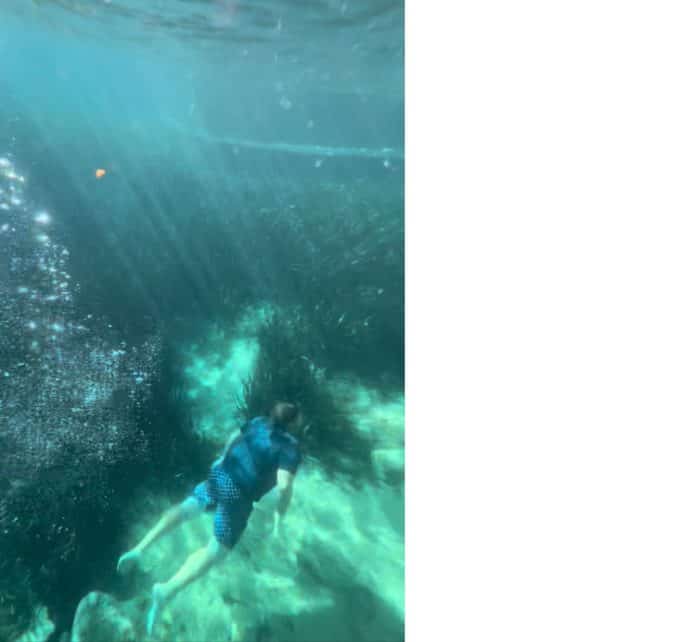 man swimming underwater in Juniper Springs