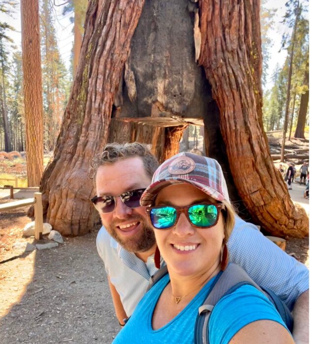 couple in front of California tunnel tree at Mariposa Grove 