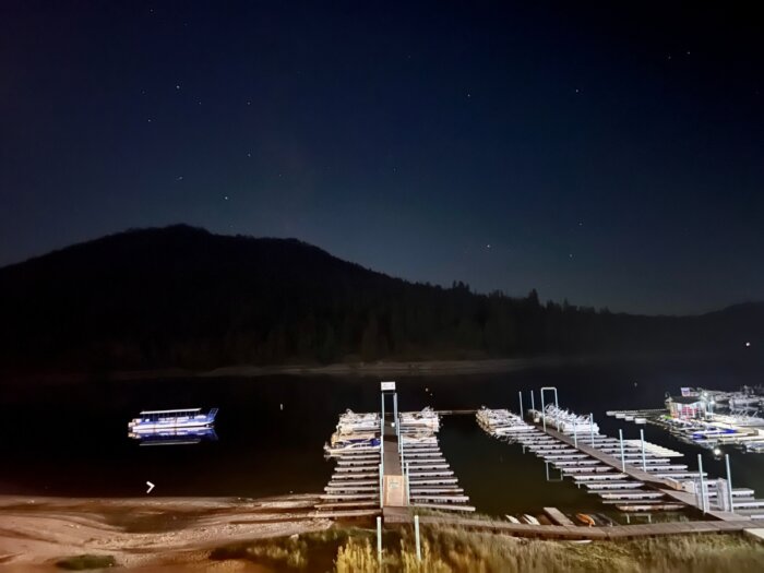 view of Bass Lake at night from the Pines Resort