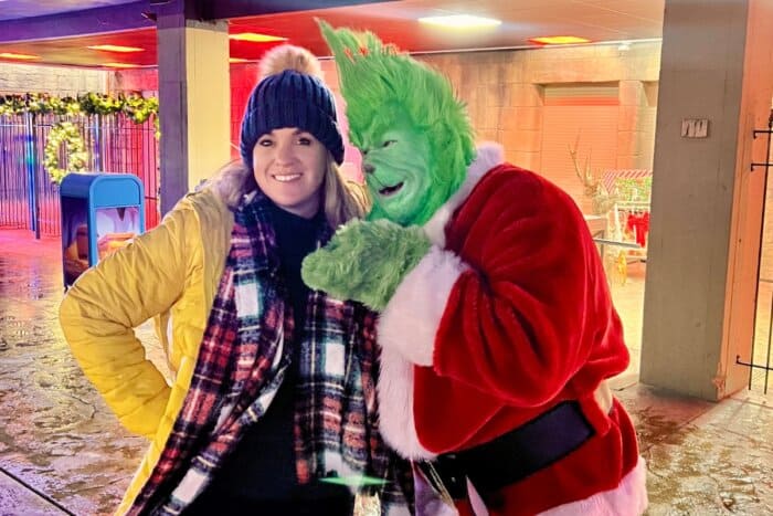 woman and Grinch at Land of Illusion Christmas Glow 