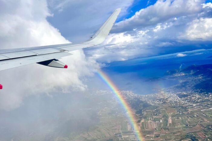 air plane with a rainbow in the sky