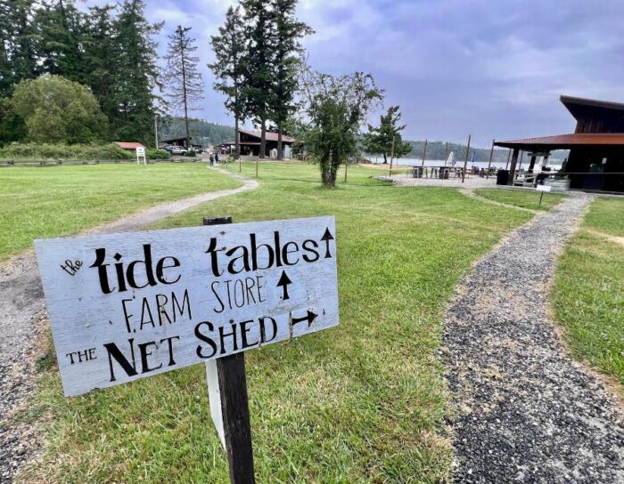 sign for tide tables Westcott Bay Shellfish Farm on San Juan Island