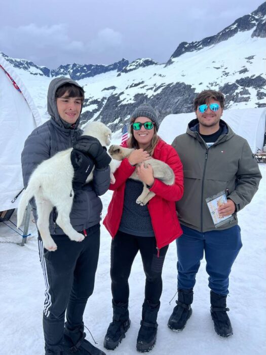 family with puppies on a glacier