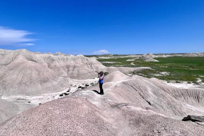 woman taking pictures at Toadstool Geological Park in Nebraska 