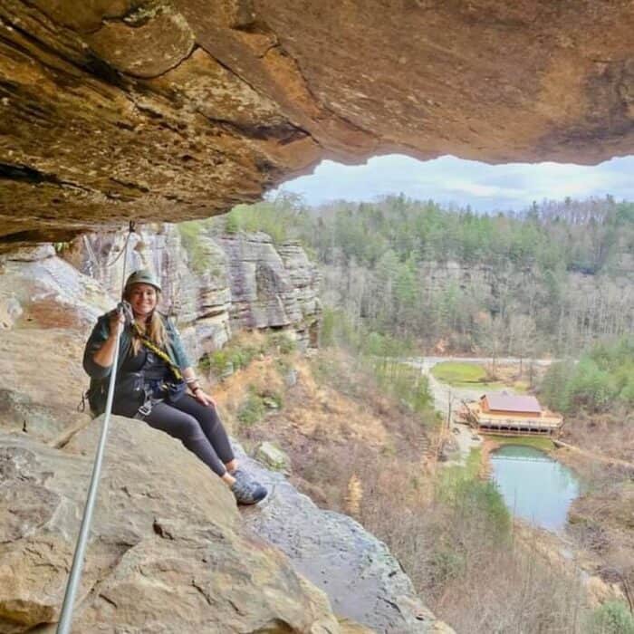 woman climbing Via ferrata with Southeast Mountain Guides in Kentucky