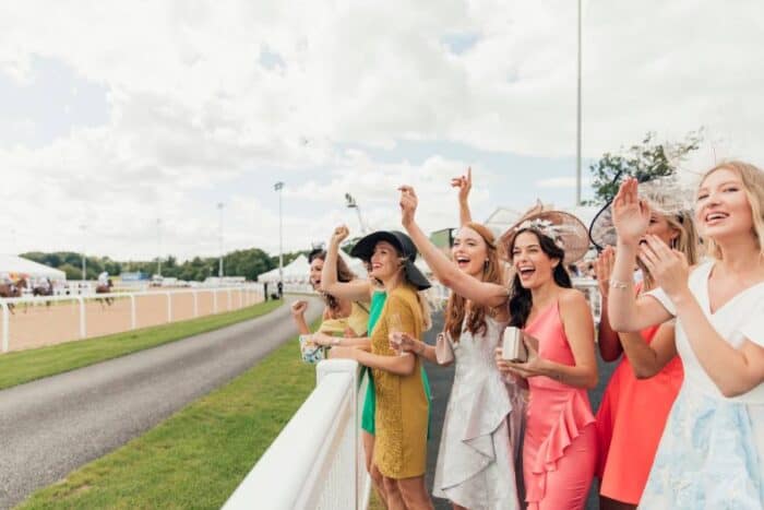 women at horse race in the spring