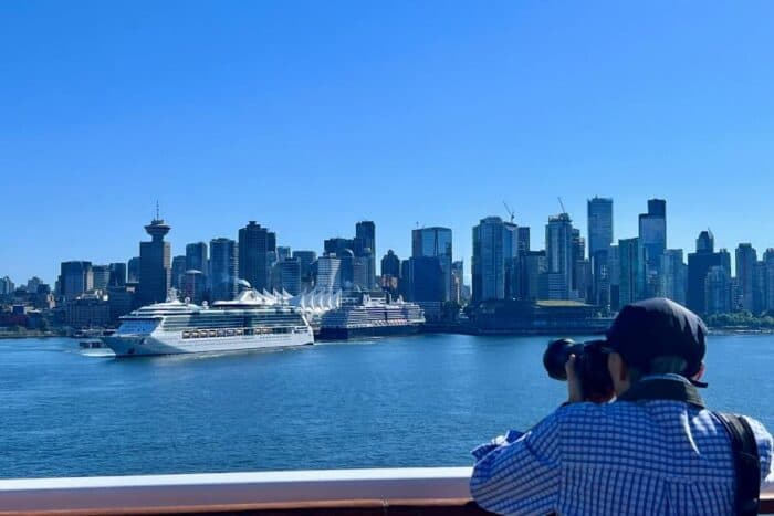 man taking a photo of a cruise ship