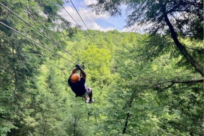 man ziplining Treetops Zipline Canopy Tour