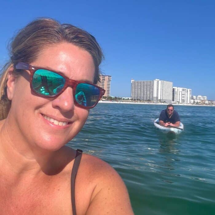 couple on inflatable stand up paddleboards in the ocean 