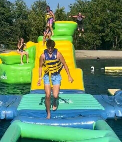 teenager on inflatable obstacle course Land of Illusion Aqua Adventures Waterpark