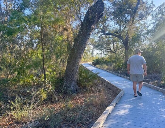 young man hiking the Jeff Friend Trail in Bon Secour National Wildlife Refuge
