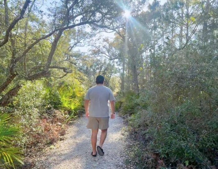 young man hiking the Jeff Friend Trail in Bon Secour National Wildlife Refuge