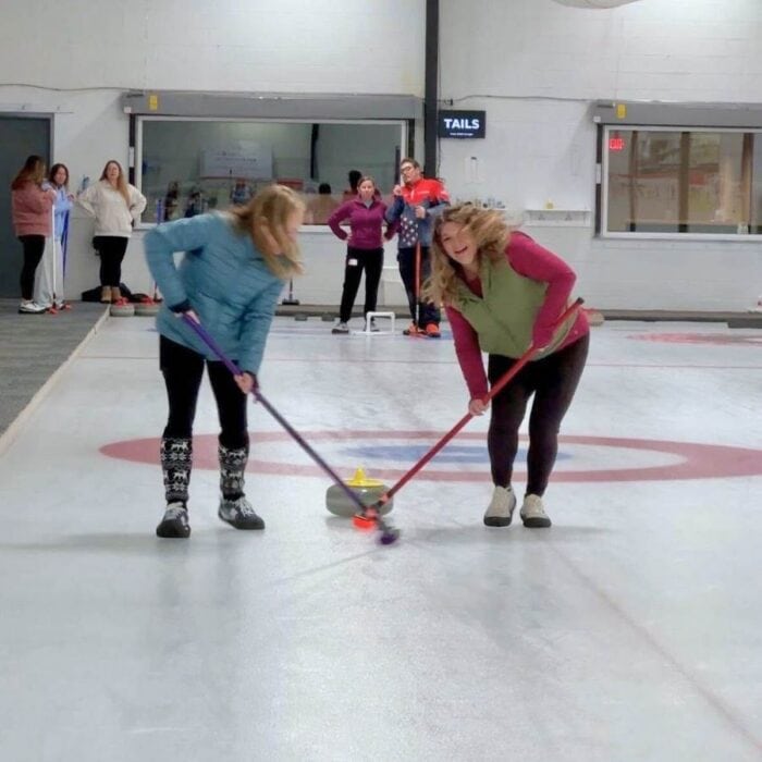 Learn to curl class sweeping during a Learn to Curl class with Cincinnati Curling Club